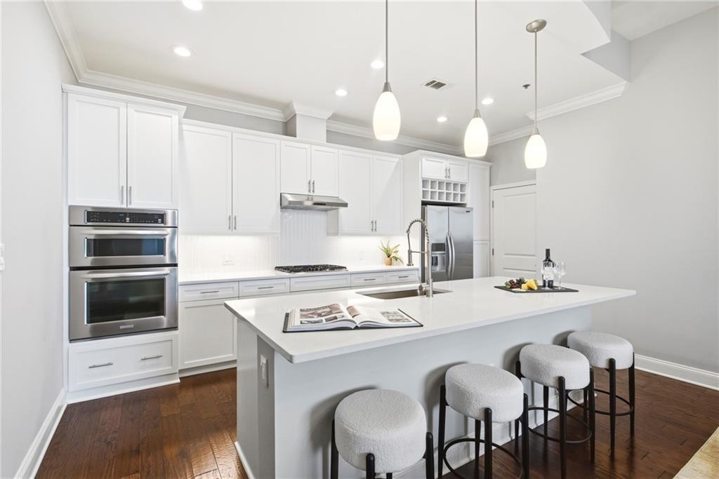 270 17th Street Northwest, Unit 4306 Atlanta, GA 30363 - Photo 1 of 37 a kitchen with a stove a table and chairs