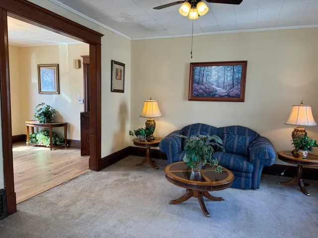 a living room with furniture and a chandelier
