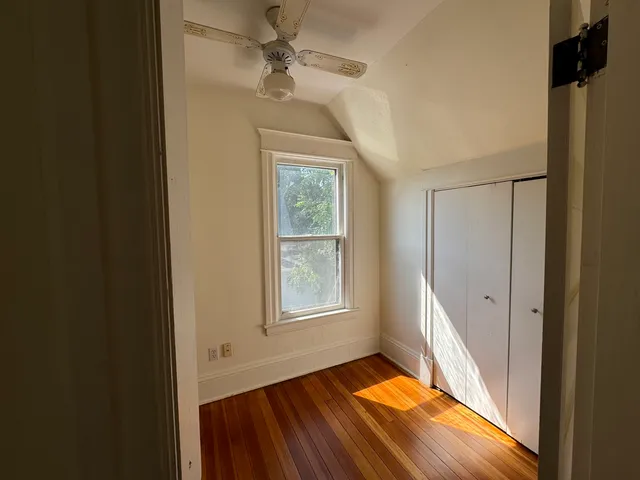 an empty room with windows and closet