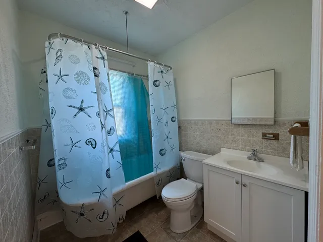 a bathroom with a toilet sink and shower