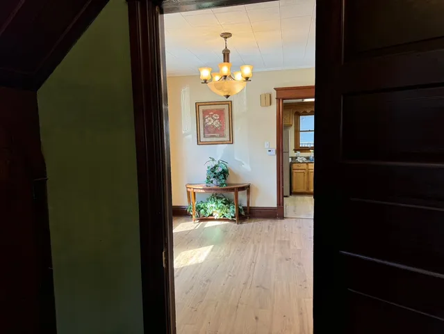 a dining room with furniture and wooden floor