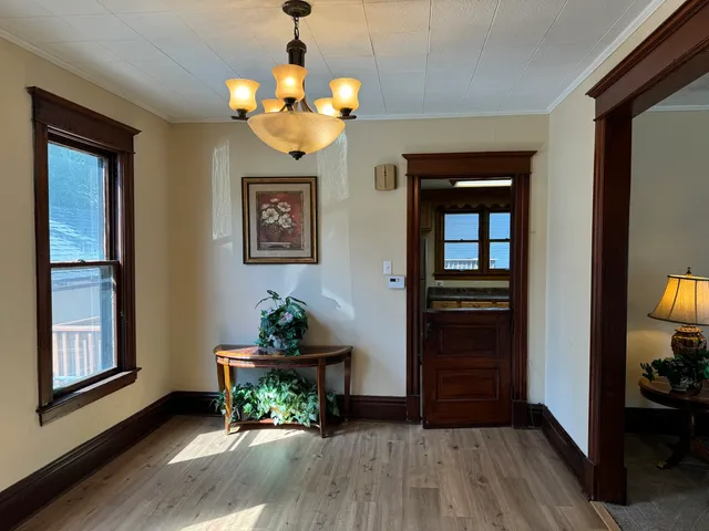 a living room with furniture and a chandelier