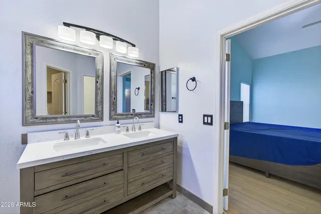 a bathroom with a double vanity sink and a mirror
