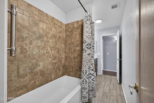 a bathroom with a bathtub and shower