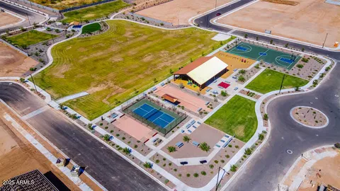 a backyard of a house with barbeque oven table and chairs