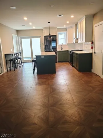 a kitchen with stainless steel appliances a sink counter space and a window