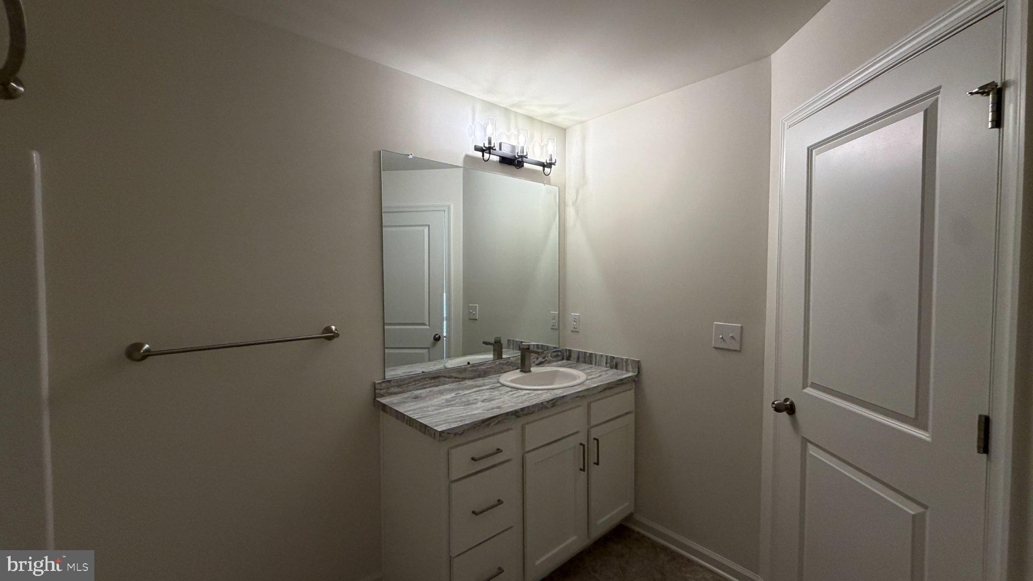 78 Tansboro Road Berlin, NJ 08009 - Photo 36 of 41 a bathroom with a granite countertop sink and a mirror