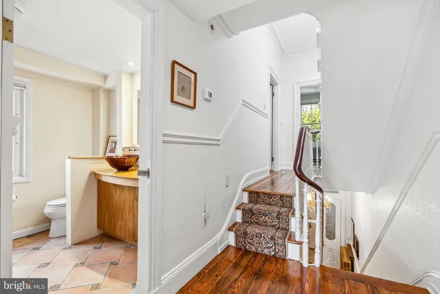 a bathroom with a granite countertop sink a toilet and a bathtub