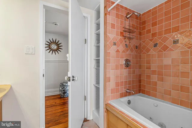 a view of a livingroom with furniture a ceiling fan and wooden floor