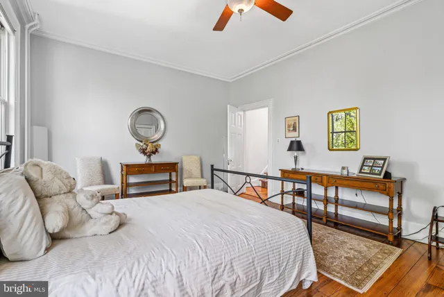 a living room with furniture and a book shelf