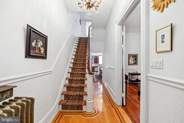 a view of entryway and hall with wooden floor