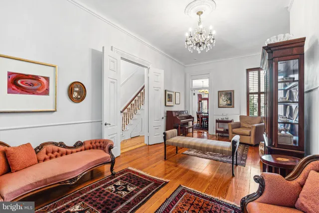 a living room with furniture and a chandelier