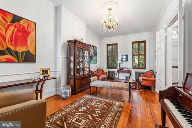 a living room with furniture a rug and a chandelier