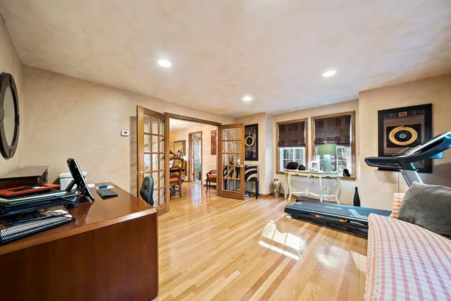 a living room with furniture a wooden floor and a flat screen tv