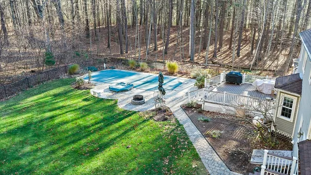 a view of a house with a big yard and large trees