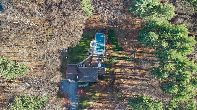 a backyard of a house with a yard and outdoor seating