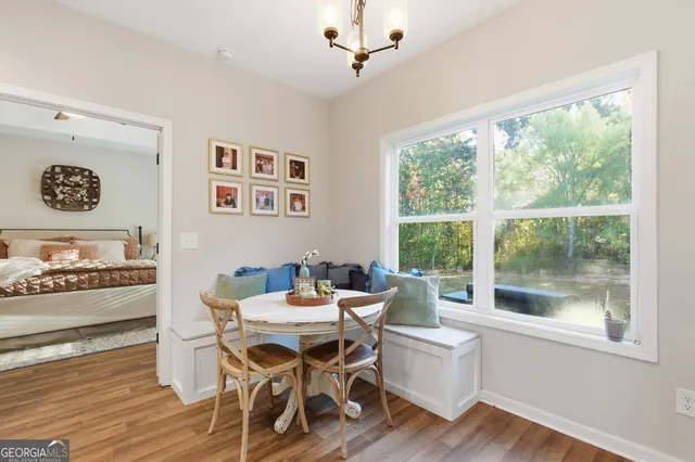 a dining room with wooden floor and a window