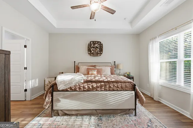 a bed sitting in a bedroom next to a window