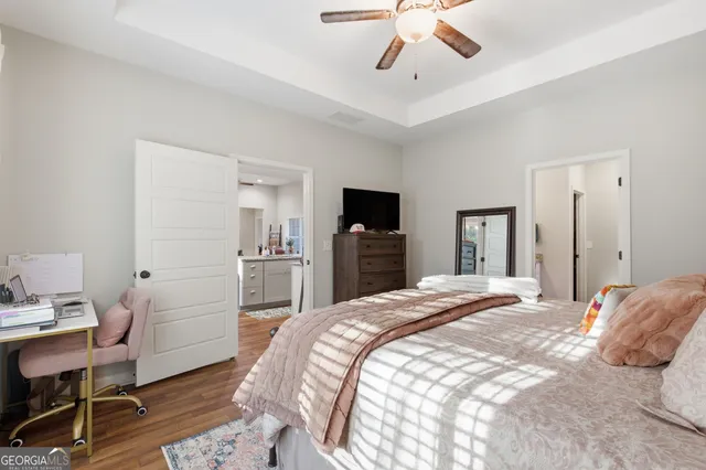 a bedroom with a bed and a flat screen tv