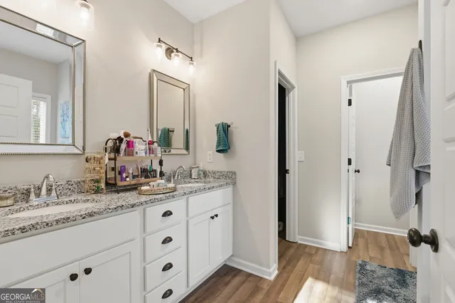 a bathroom with a double vanity sink and mirror