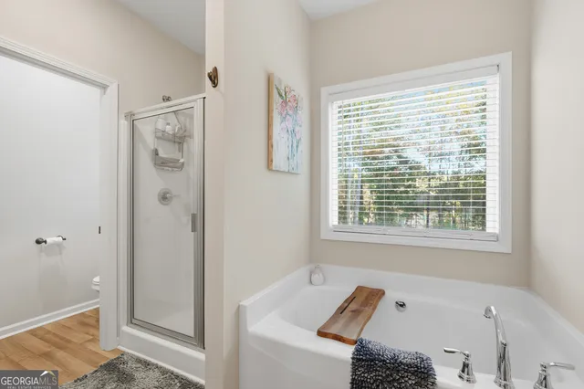 a bathroom with a tub shower and sink