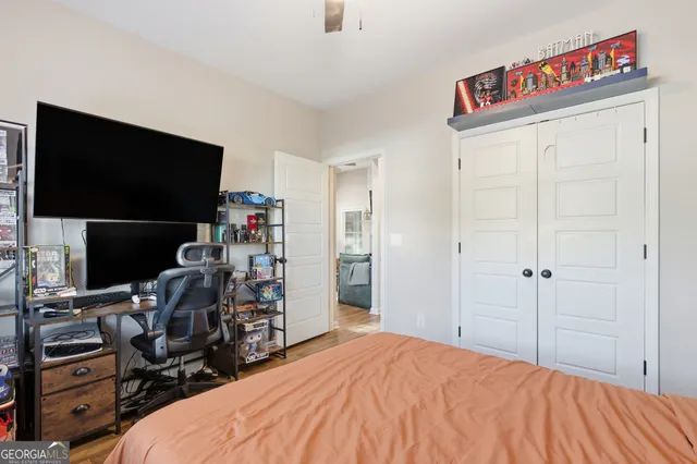 a bedroom with a bed and a flat screen tv