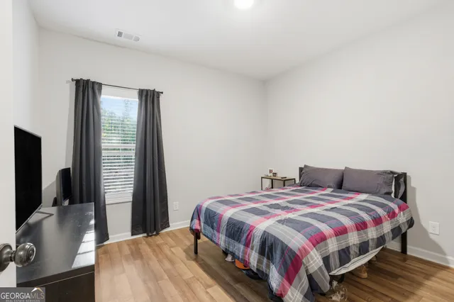 a bedroom with a bed and a flat screen tv