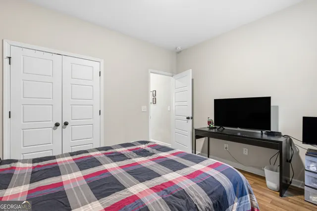 a bedroom with a bed and a flat screen tv