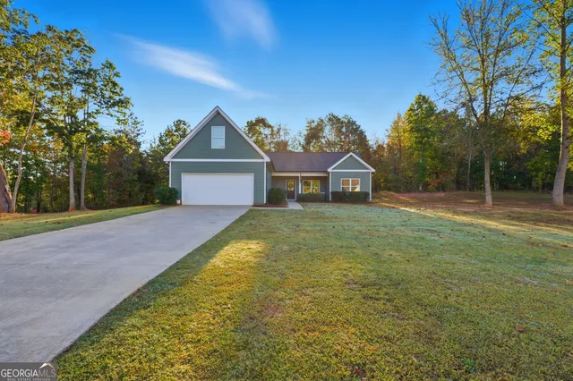 a house with green field in front of it