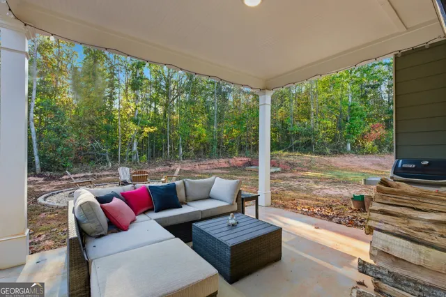a living room with furniture and a floor to ceiling window