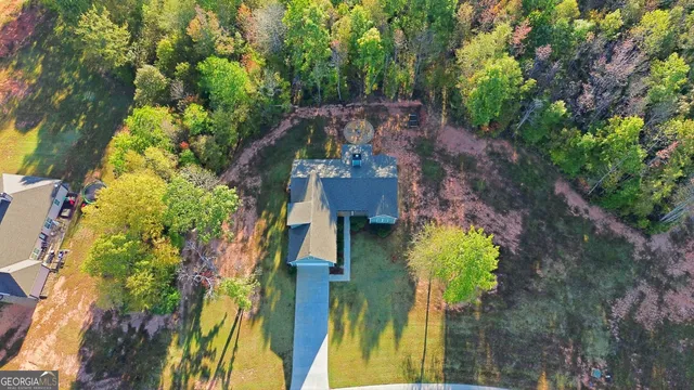 an aerial view of a house with a yard swimming pool and outdoor seating
