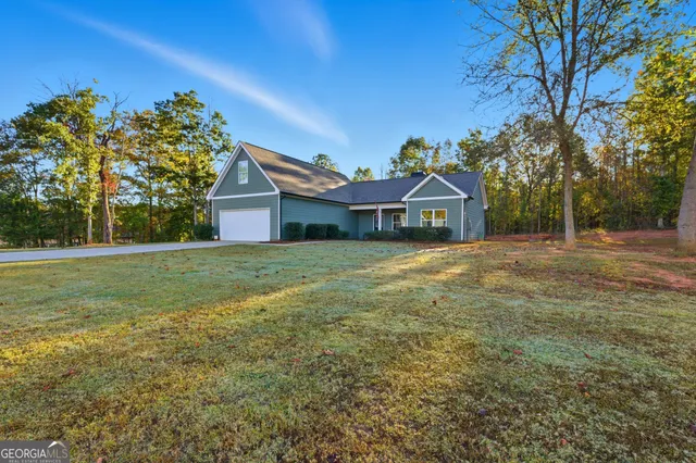 a front view of house with yard and trees