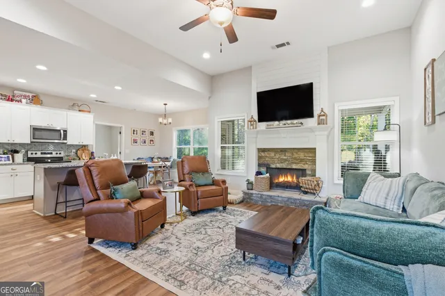 a living room with furniture fireplace and a flat screen tv