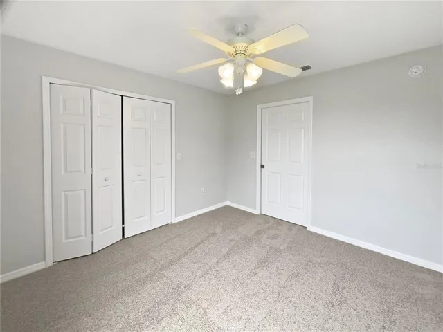 a view of an empty room and closet area