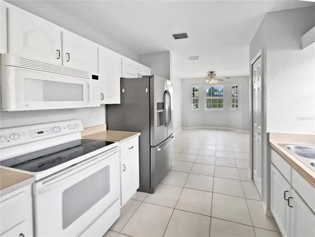 a kitchen with a stove a sink and a refrigerator