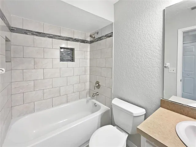 a bathroom with a toilet a sink and bathtub
