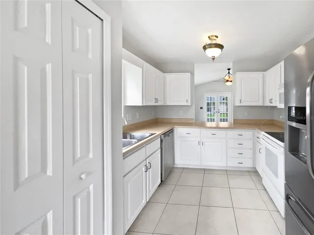 a spacious bathroom with a granite countertop sink a mirror and a shower