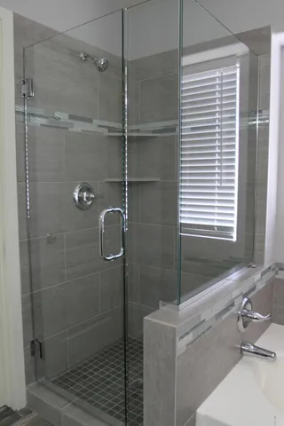 a bathroom with a bathtub and shower