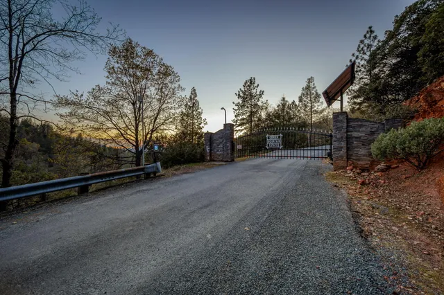 a view of a road with a house in the background