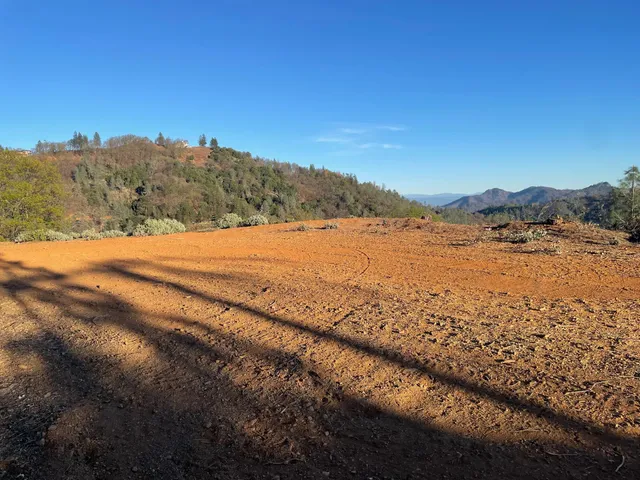 a view of a mountain range with trees