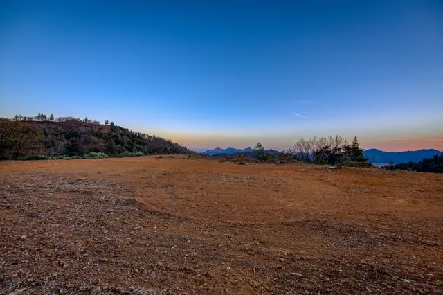 a view of dirt yard and mountain view