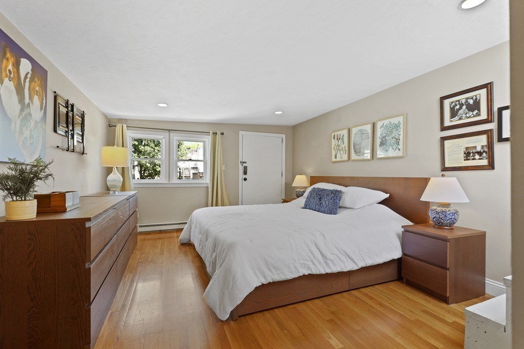 522 East 8th Street, Unit 3 Boston, MA 02127 - Photo 11 of 16 a bedroom with a large bed couch and two windows