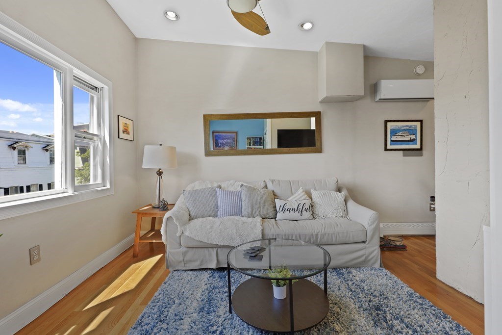 522 East 8th Street, Unit 3 Boston, MA 02127 - Photo 2 of 16 a living room with furniture and a rug