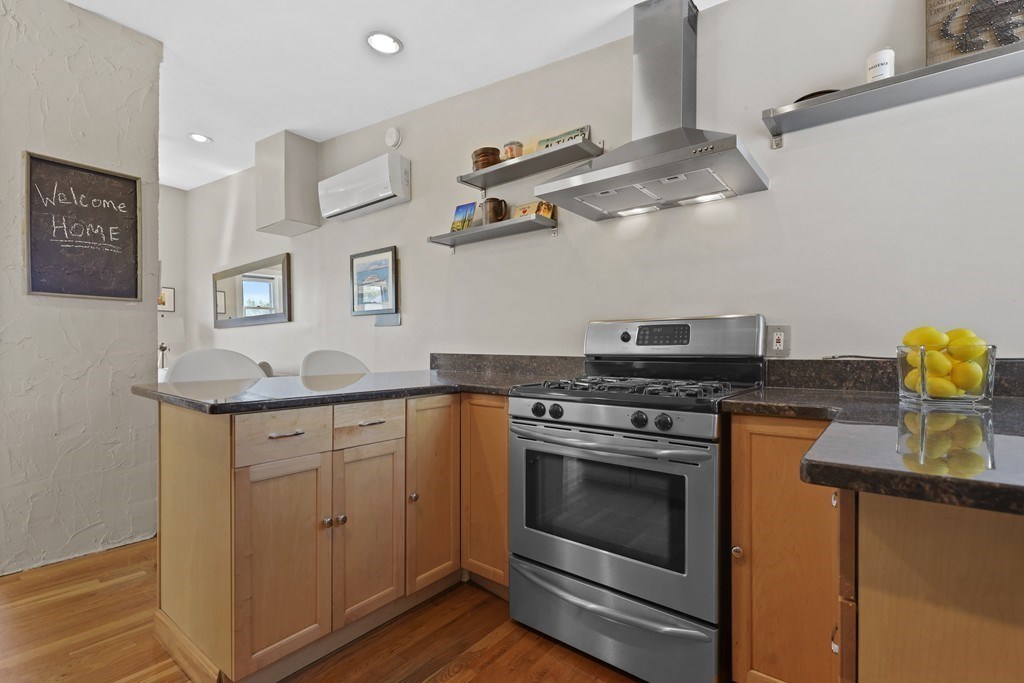 522 East 8th Street, Unit 3 Boston, MA 02127 - Photo 7 of 16 a kitchen with stainless steel appliances granite countertop a stove and a sink