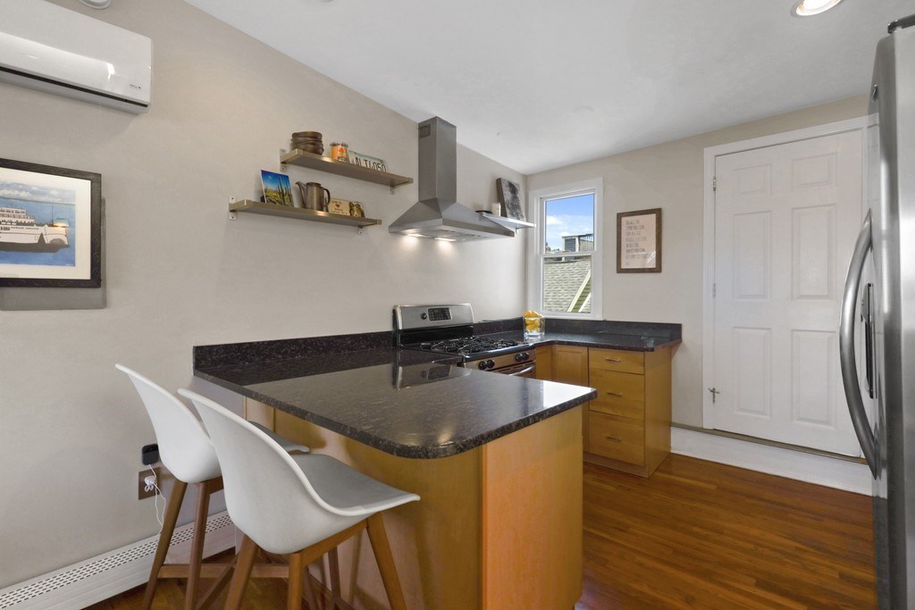 522 East 8th Street, Unit 3 Boston, MA 02127 - Photo 8 of 16 a kitchen with stainless steel appliances granite countertop a sink dishwasher and a refrigerator with wooden floor