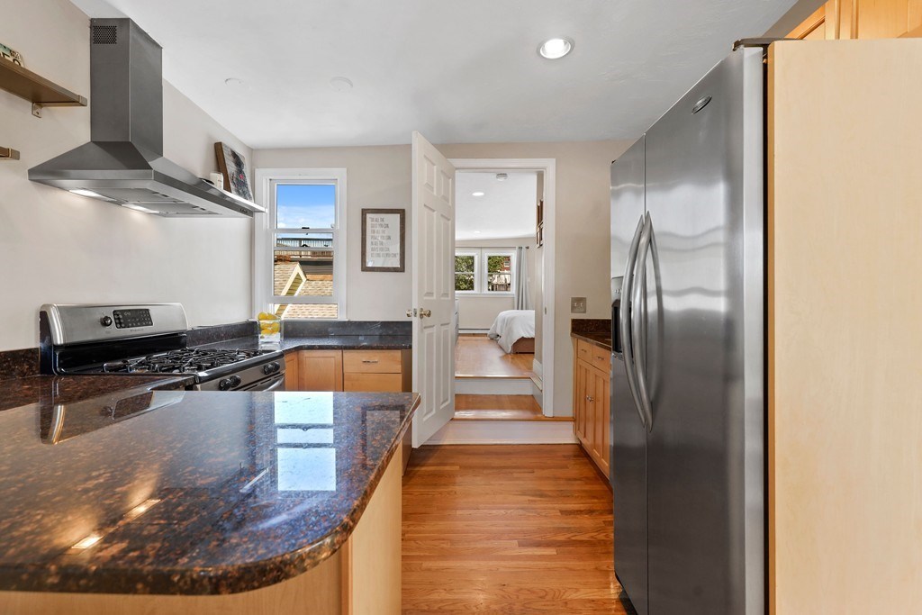522 East 8th Street, Unit 3 Boston, MA 02127 - Photo 9 of 16 a kitchen with stainless steel appliances granite countertop a refrigerator a stove and a sink
