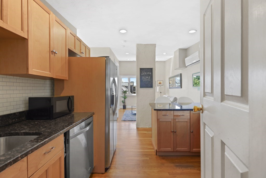 522 East 8th Street, Unit 3 Boston, MA 02127 - Photo 10 of 16 a kitchen with stainless steel appliances granite countertop a refrigerator a stove and a sink
