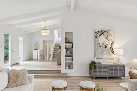 a living room with furniture and a toilet