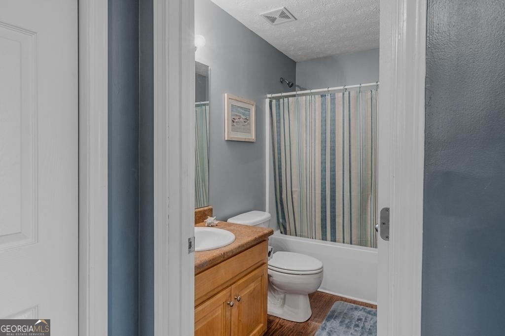 80 Upper Caldwell Road Bowdon, GA 30108 - Photo 20 of 33 a bathroom with a granite countertop sink toilet and shower