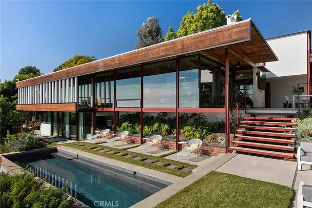 a view of a patio with couches table and chairs and potted plants